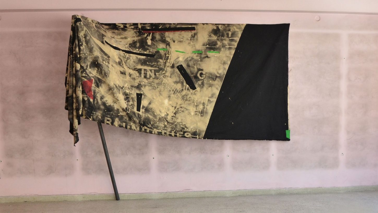 Anestis Ioannou, <i>One Man Flag II</i>, 2017, spray paint on bleached denim, 210x380 cm, installation view from <i>Since when don't they like pink?</i> at Back to Athens, Greece